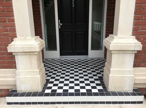 Front porch and step tiled in a black and white chequerboard pattern