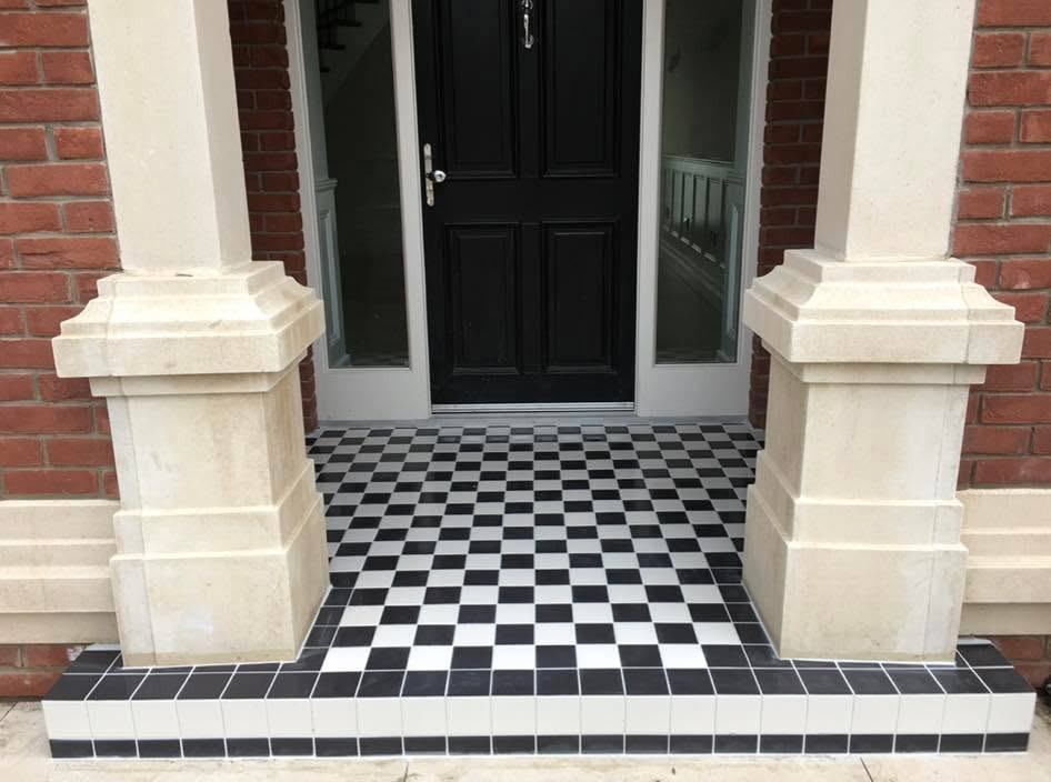 Front porch and step tiled in a black and white chequerboard pattern